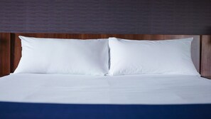 A neatly made bed with white linens and a wooden headboard. - Holiday Inn Express Madrid-Alcorcón by IHG (Alcorcon)