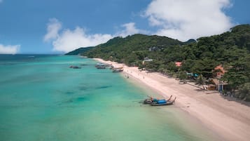 On the beach, white sand, beach umbrellas, beach towels