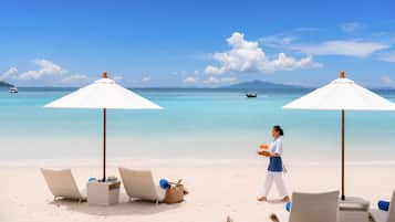 On the beach, white sand, beach umbrellas, beach towels