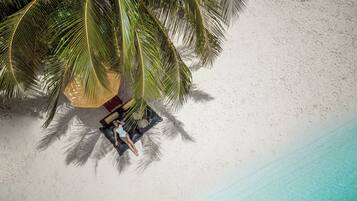 On the beach, white sand, beach umbrellas, beach towels