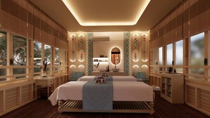 A spacious bedroom with a large bed, a vanity, and a mirror.