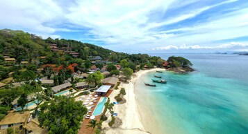 On the beach, white sand, beach umbrellas, beach towels