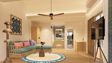 A spacious living room with a large ceiling fan, a sofa with colorful cushions, a coffee table, and a TV on a tripod stand.
