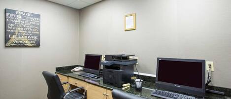 A professional office space with two desks, computers, and office chairs.
