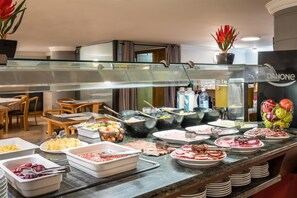 A buffet area with various food items and utensils. - ALEGRIA President (Andorra la Vella)