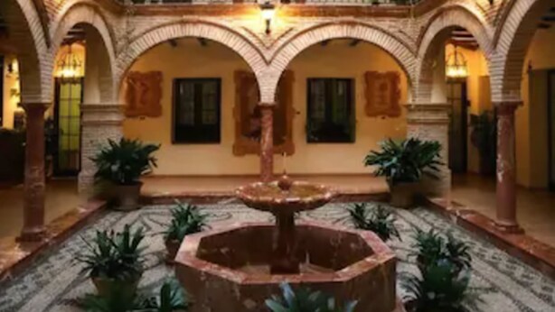 A courtyard with a central fountain, arches, and potted plants. - Hotel Domus Selecta Finca Eslava (Antequera)