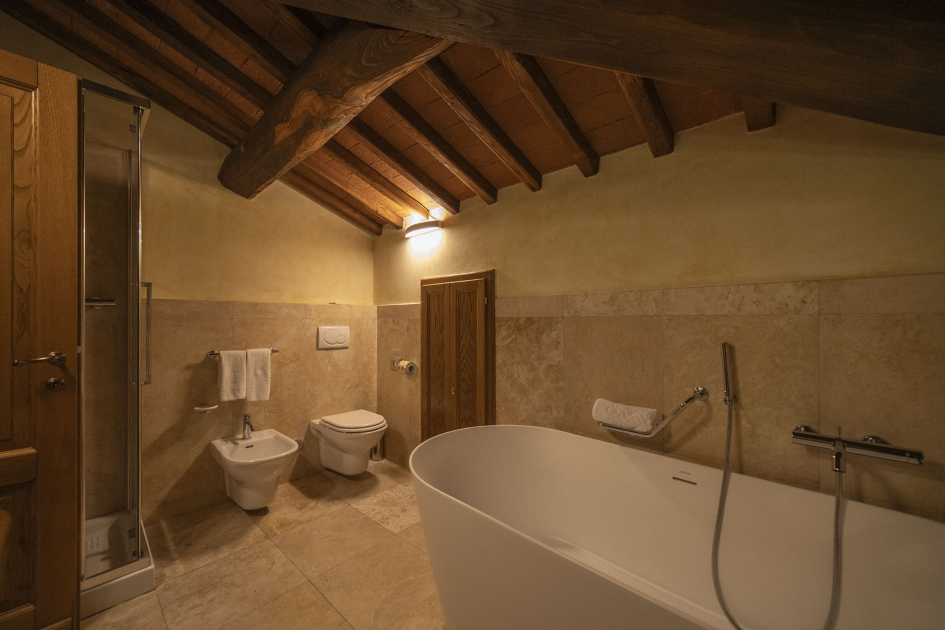 A bathroom with a freestanding bathtub, a bidet, and a toilet.