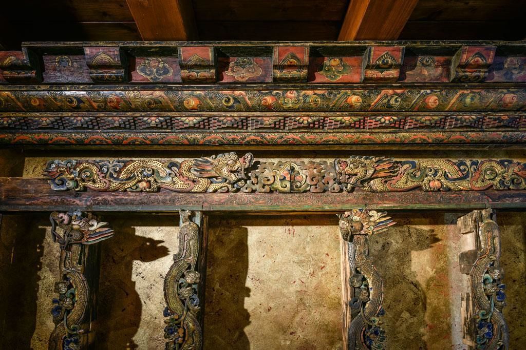 A detailed wooden structure with intricate carvings and designs.