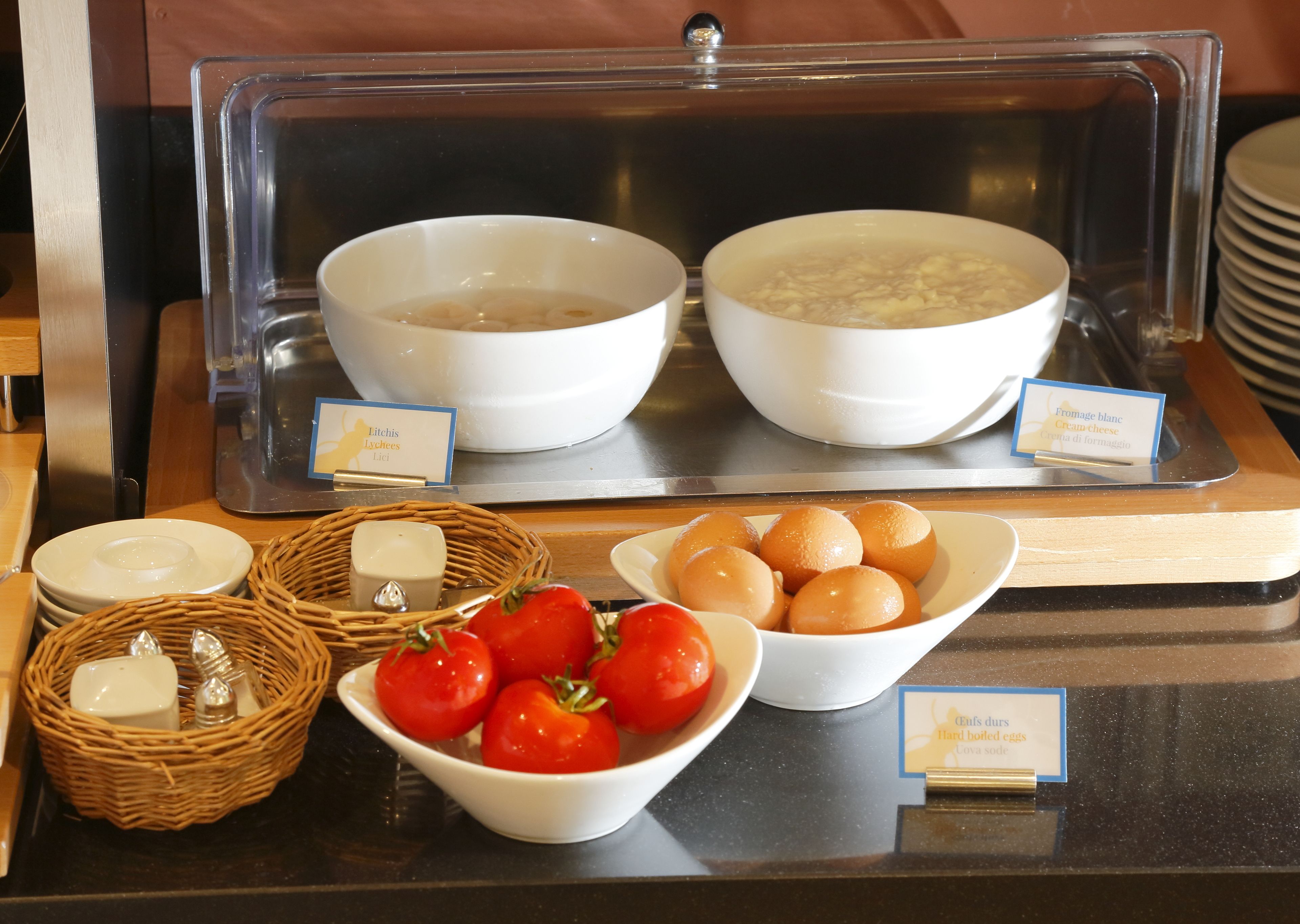 A breakfast buffet with various food items and condiments.