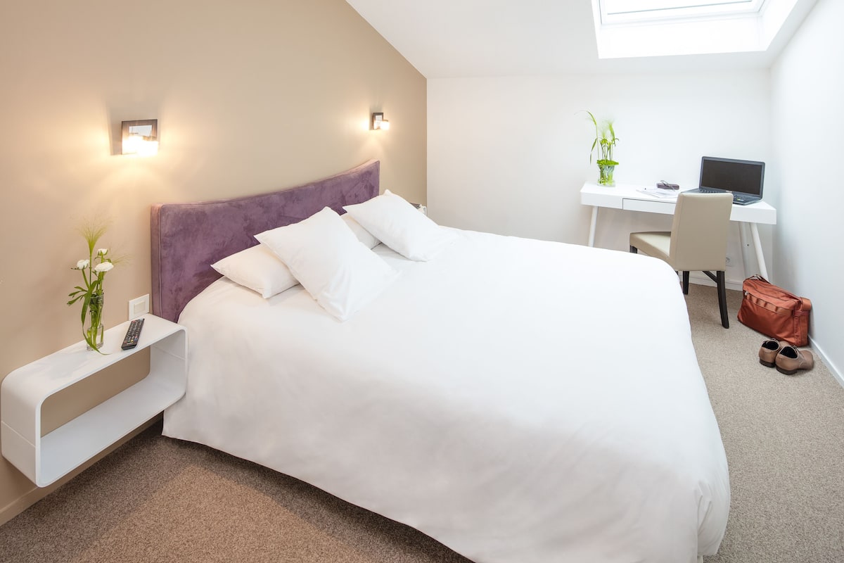 Premium bedding, desk, laptop workspace, blackout curtains
