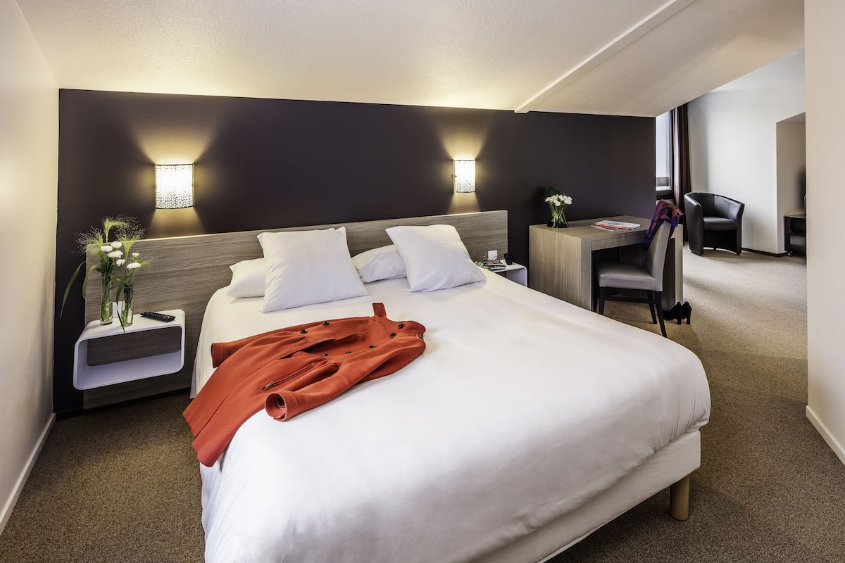 Premium bedding, desk, laptop workspace, blackout curtains