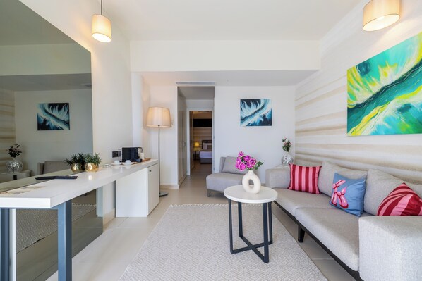 A modern living room with a sofa, a coffee table, and artwork on the walls.