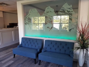 Relax in comfort with two sofas facing a scenic view through a decorative glass panel.