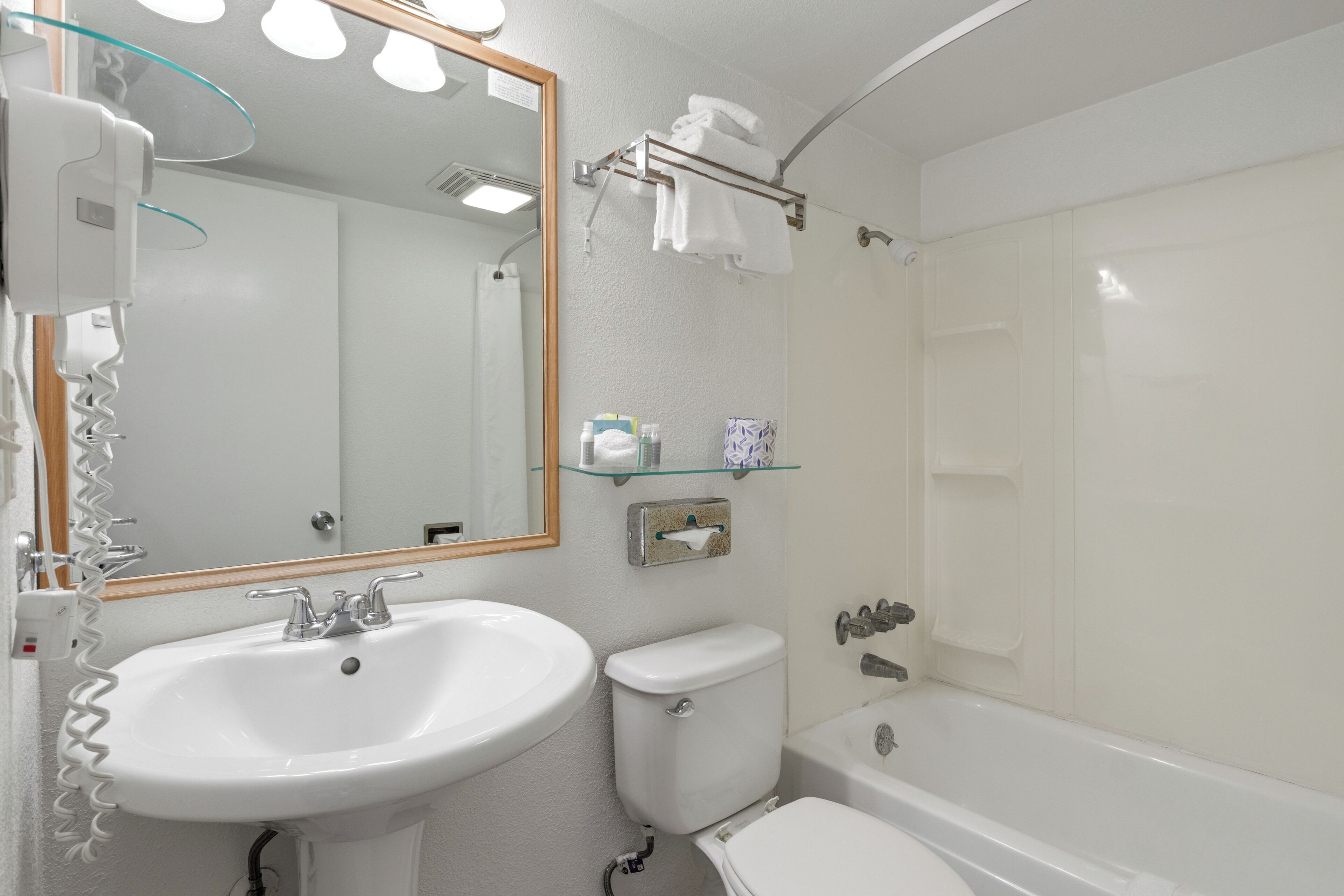 A bathroom with a sink, toilet, and bathtub.