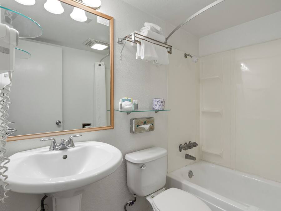 A bathroom with a sink, toilet, and bathtub.