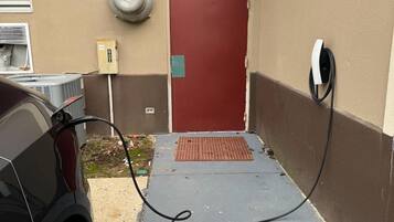 A parking area with a red door, a security camera, and a power outlet.