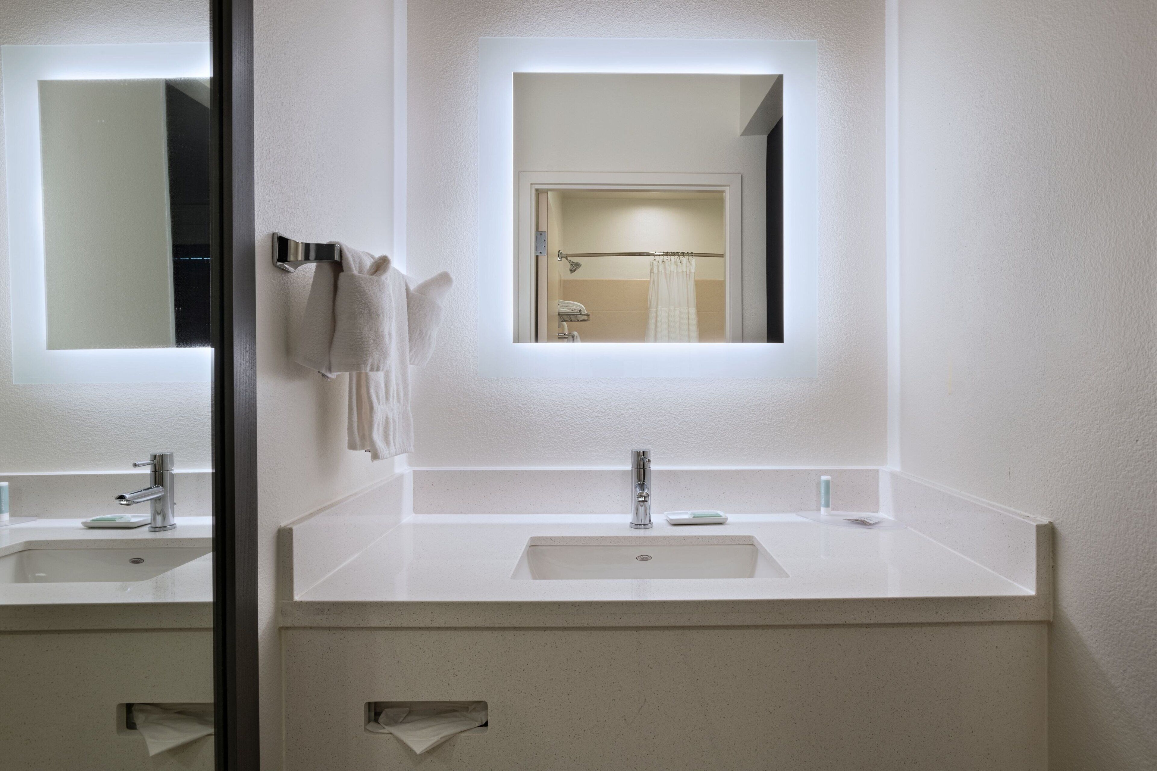 designer toiletries, hair dryer, towels, soap