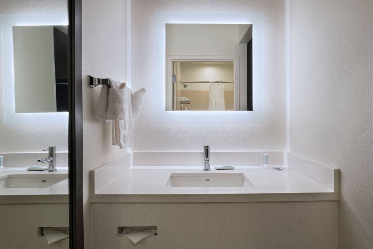 designer toiletries, hair dryer, towels, soap