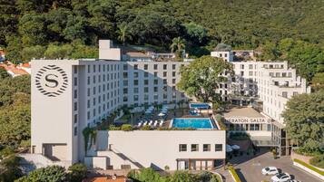 Relax by the rooftop pool amidst lush surroundings and take in the scenic views.