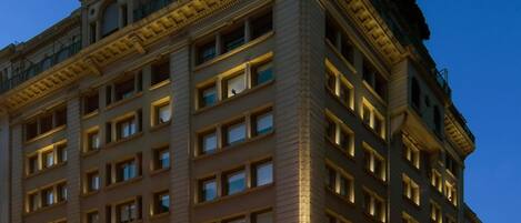 A large, multi-story hotel with a classic architectural style, featuring a prominent entrance and numerous windows.