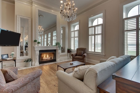 Luxury Suite, 1 King Bed with Sofa bed, River View | Living area | LED TV, books