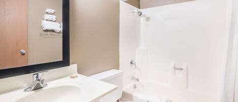 A bathroom with a sink, toilet, and shower.
