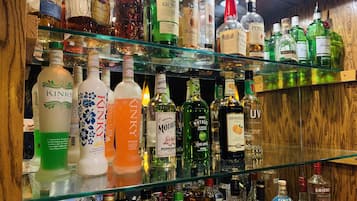 A bar with shelves stocked with various liquor bottles.