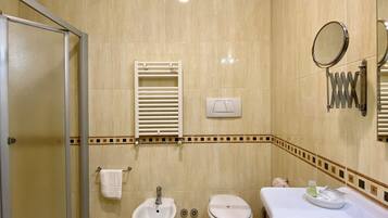 Een bad/douchecombinatie, een bubbelbad, designer toiletartikelen