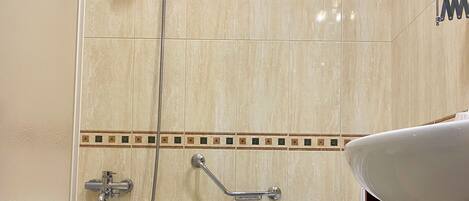 A bathroom with a bathtub, a shower, and a toilet.