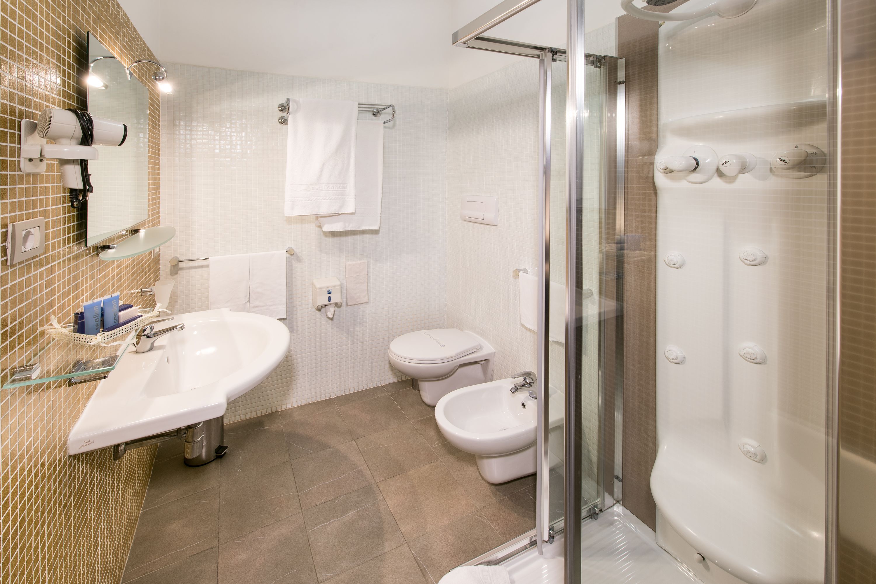 designer toiletries, hair dryer, bidet, towels