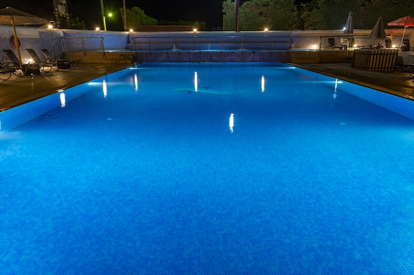 Seasonal outdoor pool, open 11:00 AM to 8:00 PM, pool umbrellas