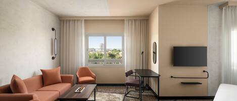 A hotel room with a sofa, armchairs, a dining table, a TV, and a large window with a city view.