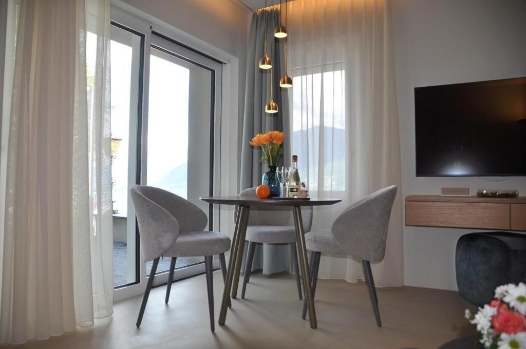 Luxury Suite, Balcony, Lake View | Dining | Breakfast and dinner served, beach views 