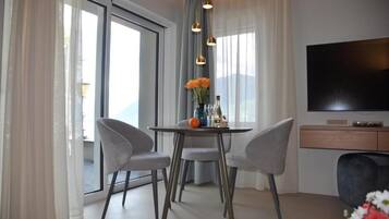 Luxury Suite, Balcony, Lake View | Dining | Breakfast and dinner served, beach views