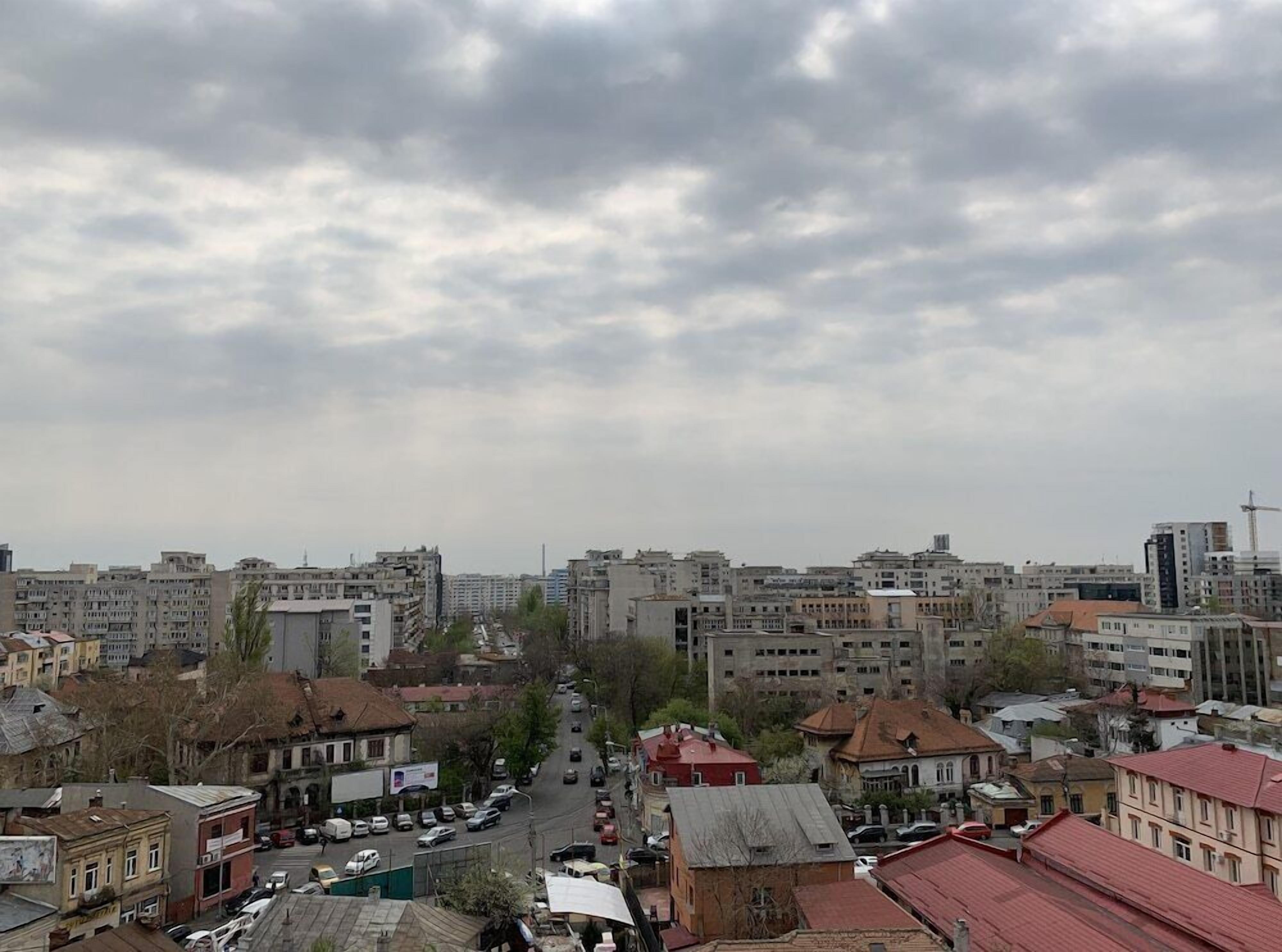 A cityscape with a variety of buildings, including residential and commercial structures.