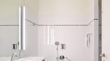 A modern bathroom with a marble sink, a bathtub, and a shower.