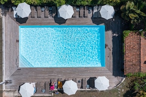 Outdoor pool, open 9:00 AM to 8 PM, pool loungers