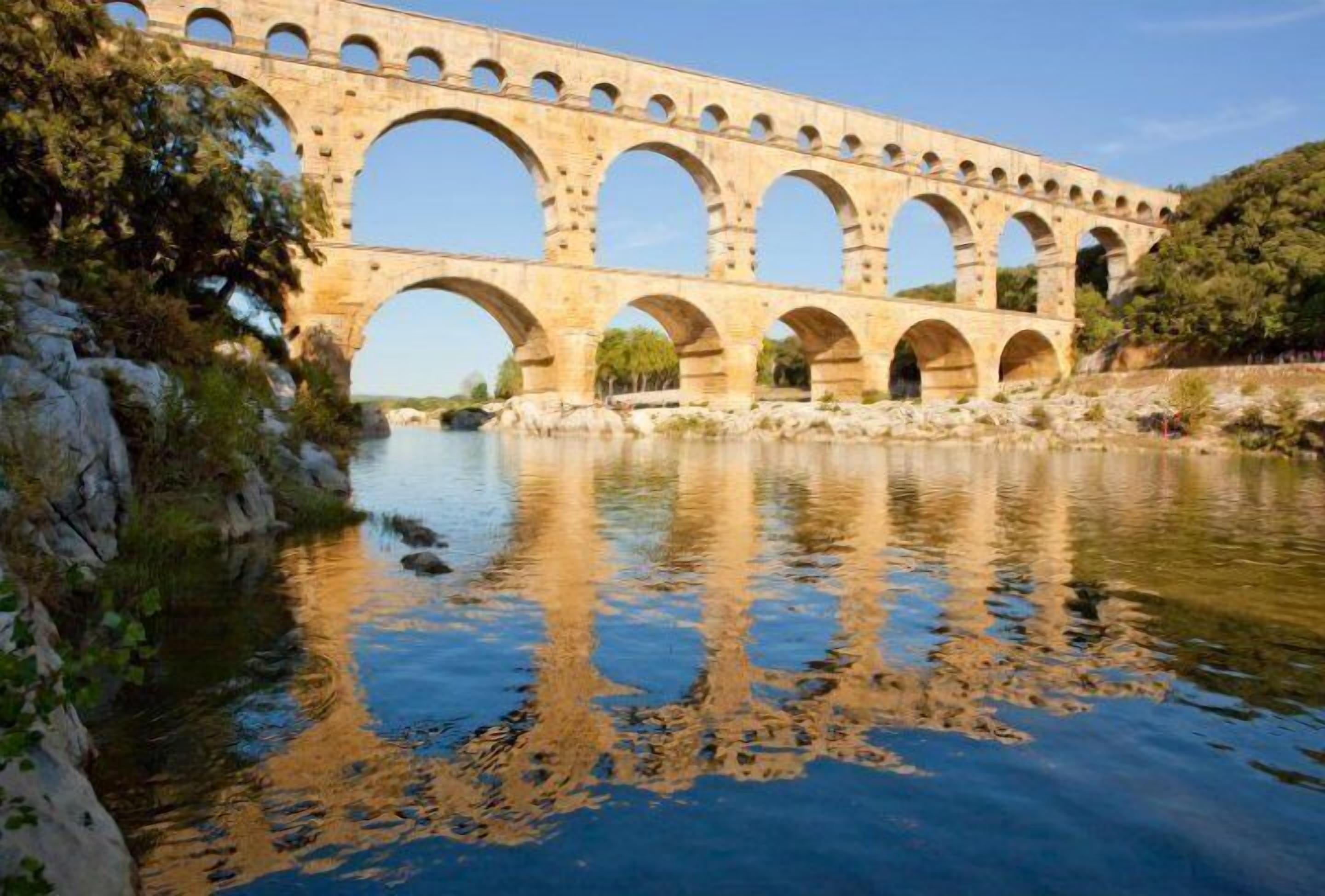 A stone aqueduct with multiple arches over a river.