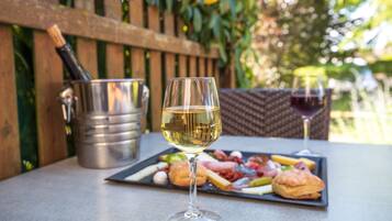 A table with a wine glass, a bottle, and a charcuterie board.
