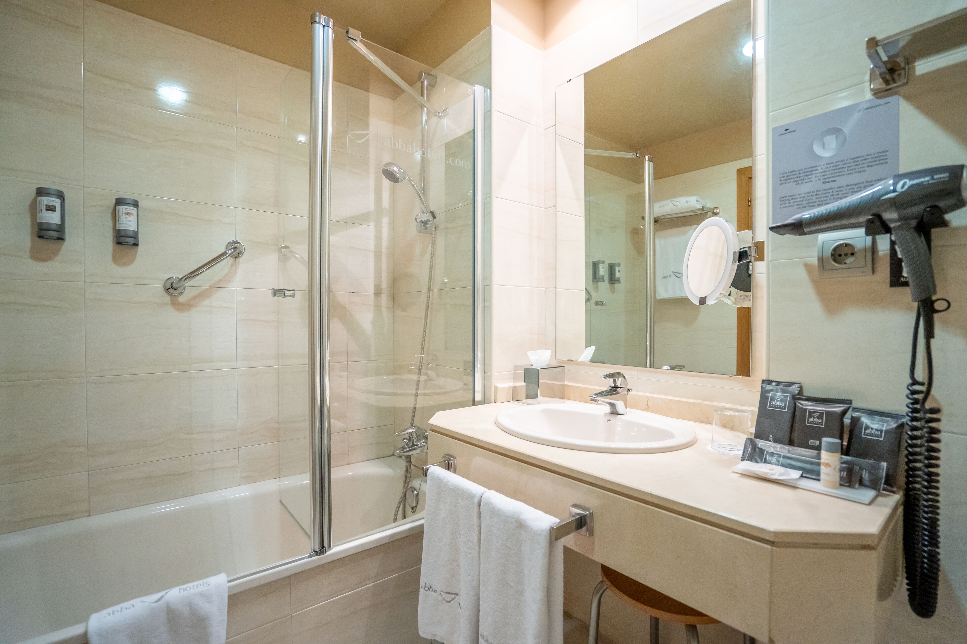 bathtub, designer toiletries, hair dryer, bidet