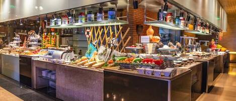 A buffet with various food items and utensils.