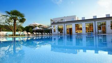 2 indoor pools, 2 outdoor pools, open 9 AM to 8 PM, pool umbrellas