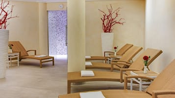 Relax in a serene spa area with wicker lounge chairs and elegant vases.
