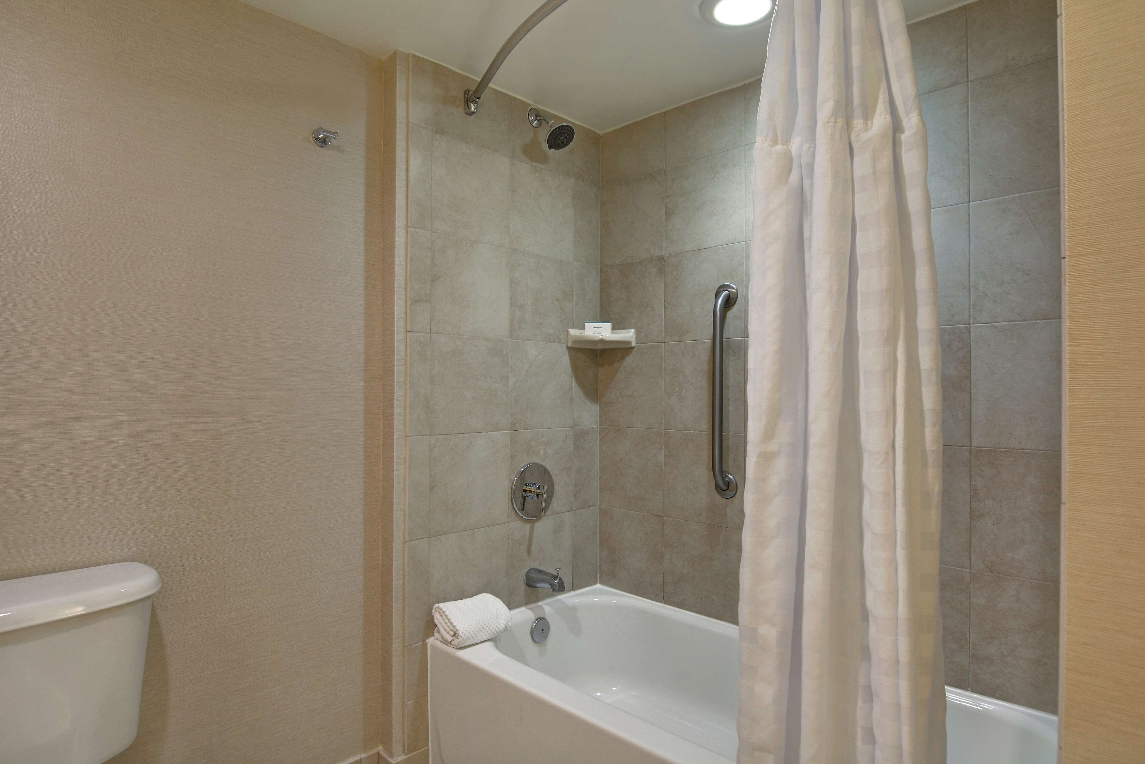 A bathroom with a bathtub, a shower, and a toilet.