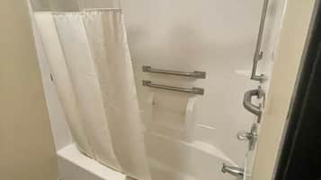 A bathroom with a bathtub, a shower, and a toilet.