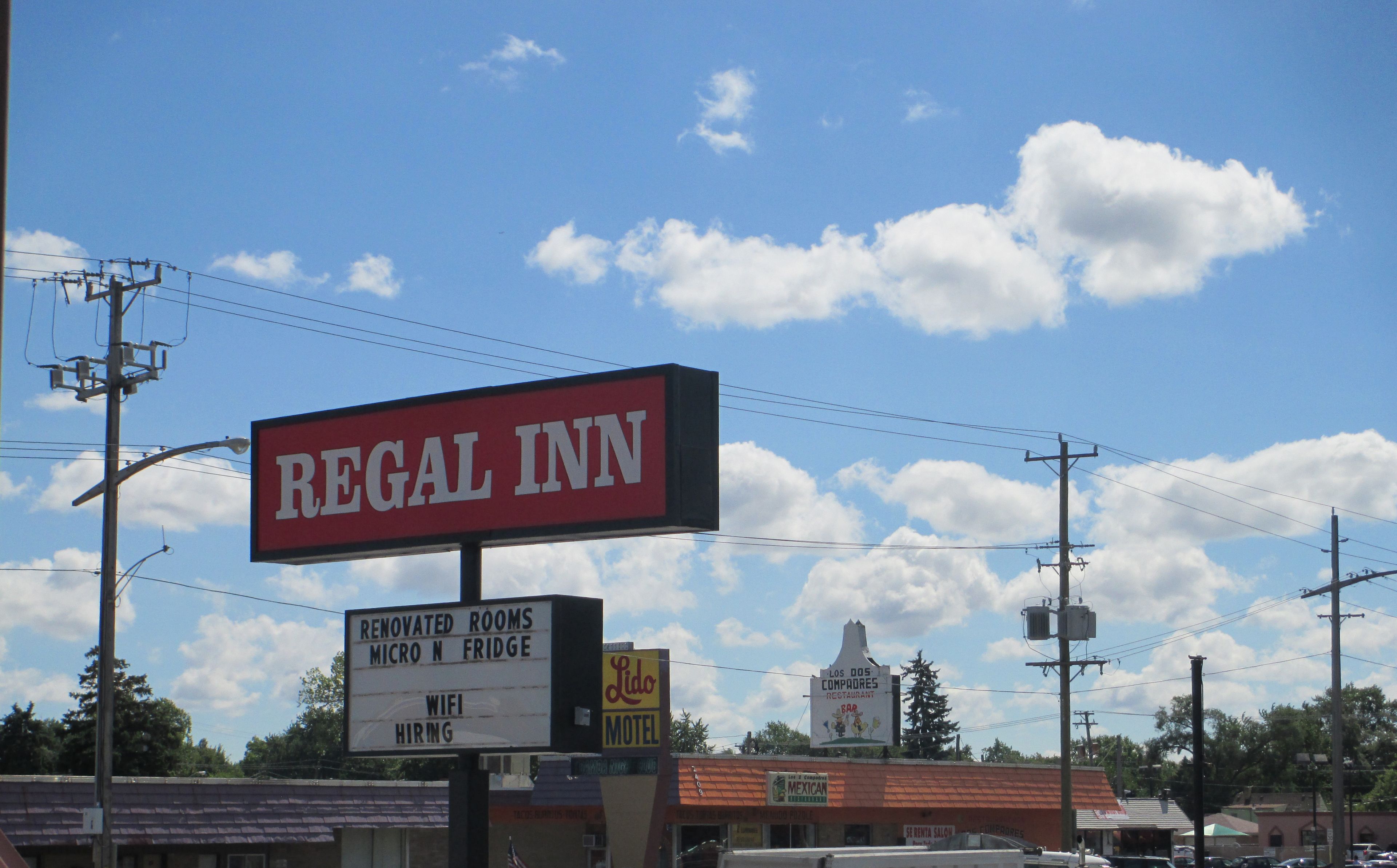 A motel sign with amenities including renovated rooms, a micro fridge, and wifi.