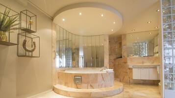 A modern bathroom with a freestanding bathtub, a large mirror, and a glass shower enclosure.
