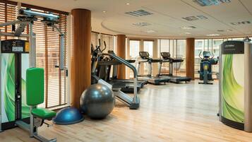 A gym with treadmills, exercise balls, and weight machines.
