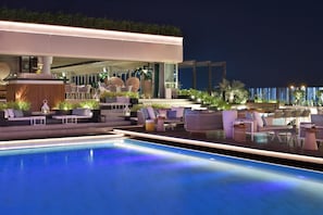 A rooftop pool area with lounge seating and a view of the city skyline at night. - Grosvenor House, a Luxury Collection Hotel, Dubai (Dubai)
