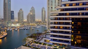 A high-rise hotel with multiple balconies overlooking a marina with boats. - Grosvenor House, a Luxury Collection Hotel, Dubai (Dubai)